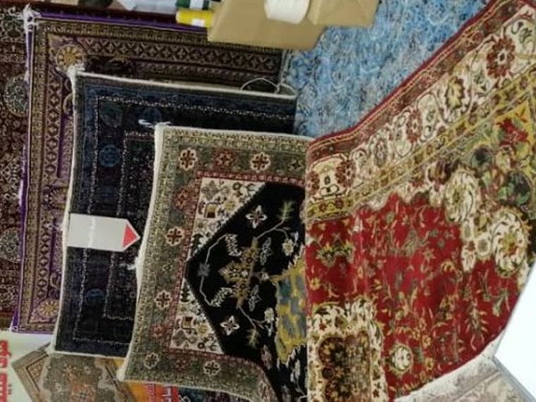 Fine rugs stacked for display